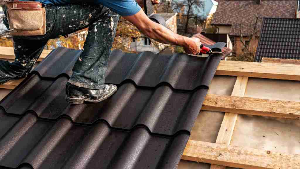 Roofer installing metal tiles, showcasing different roofing types and materials used for residential homes in San Diego.