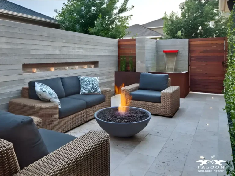 Modern outdoor patio with fire pit, concrete walls, and contemporary seating design.