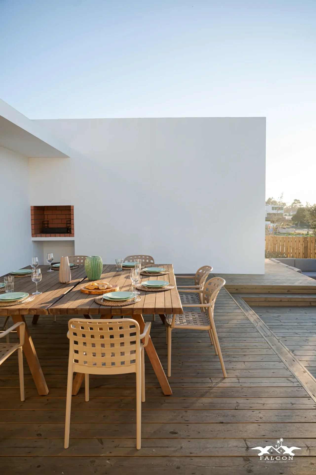 Deck construction project featuring spacious wood deck with built-in outdoor dining area and modern backyard entertainment space.
