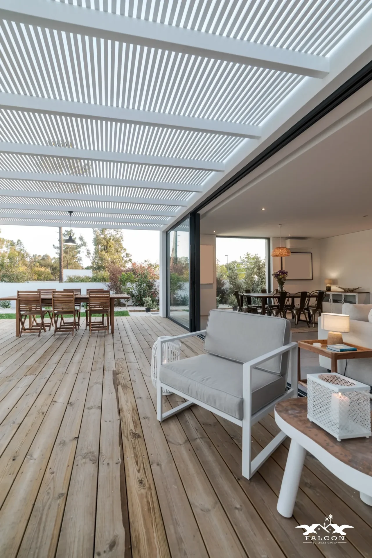Custom deck construction featuring spacious wood deck with pergola cover, outdoor dining area, and seamless indoor-outdoor living design.