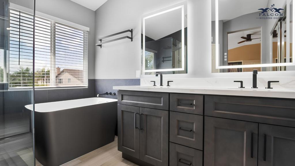 Modern bathroom remodel with black vanity cabinets, freestanding tub, and custom LED mirrors